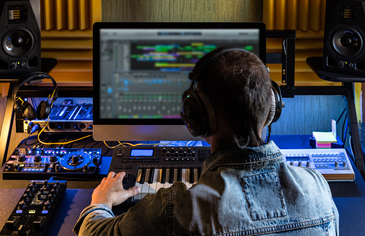 A technician edits audio on an editing station
